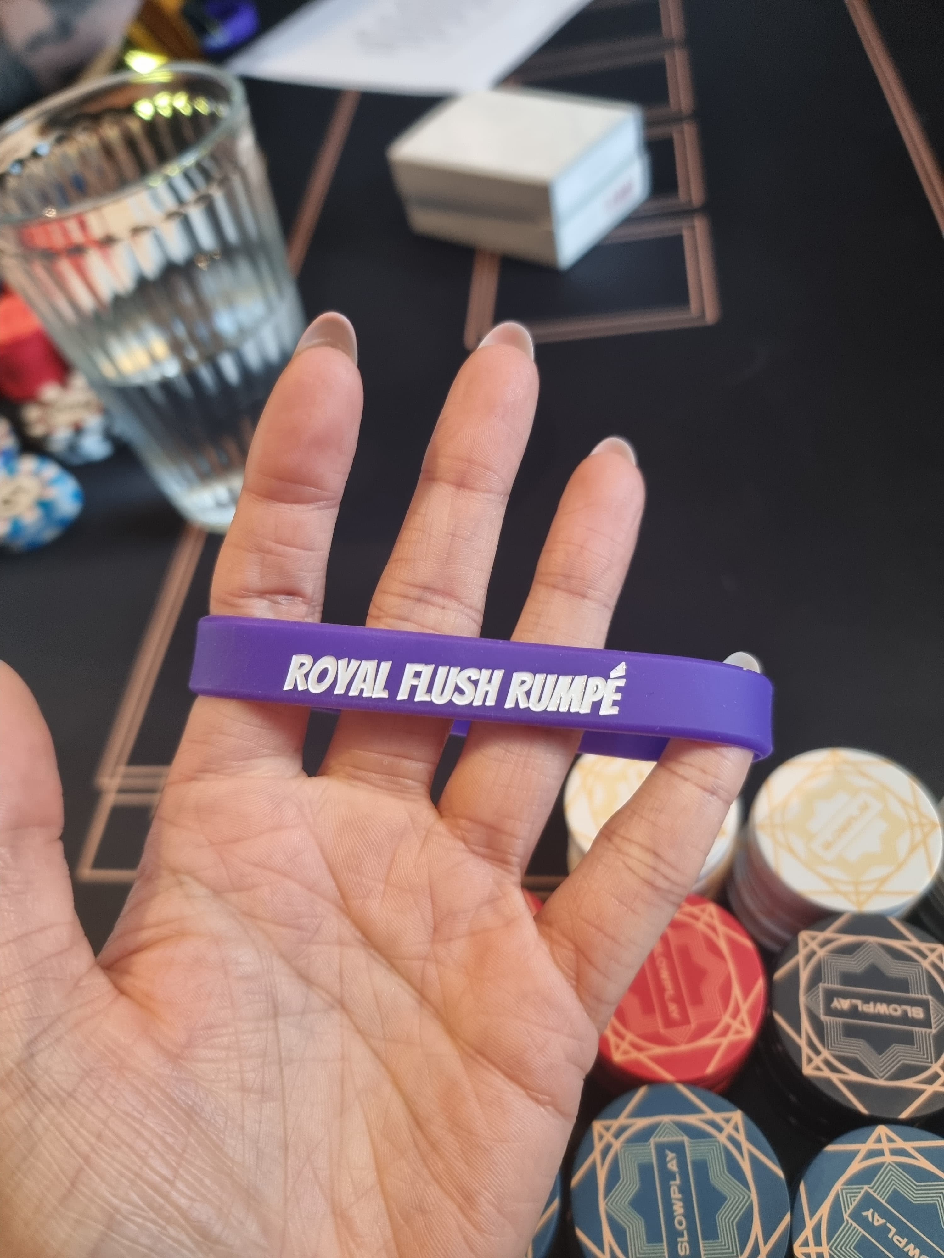 A purple Royal Flush Rumpé silicone wristband
