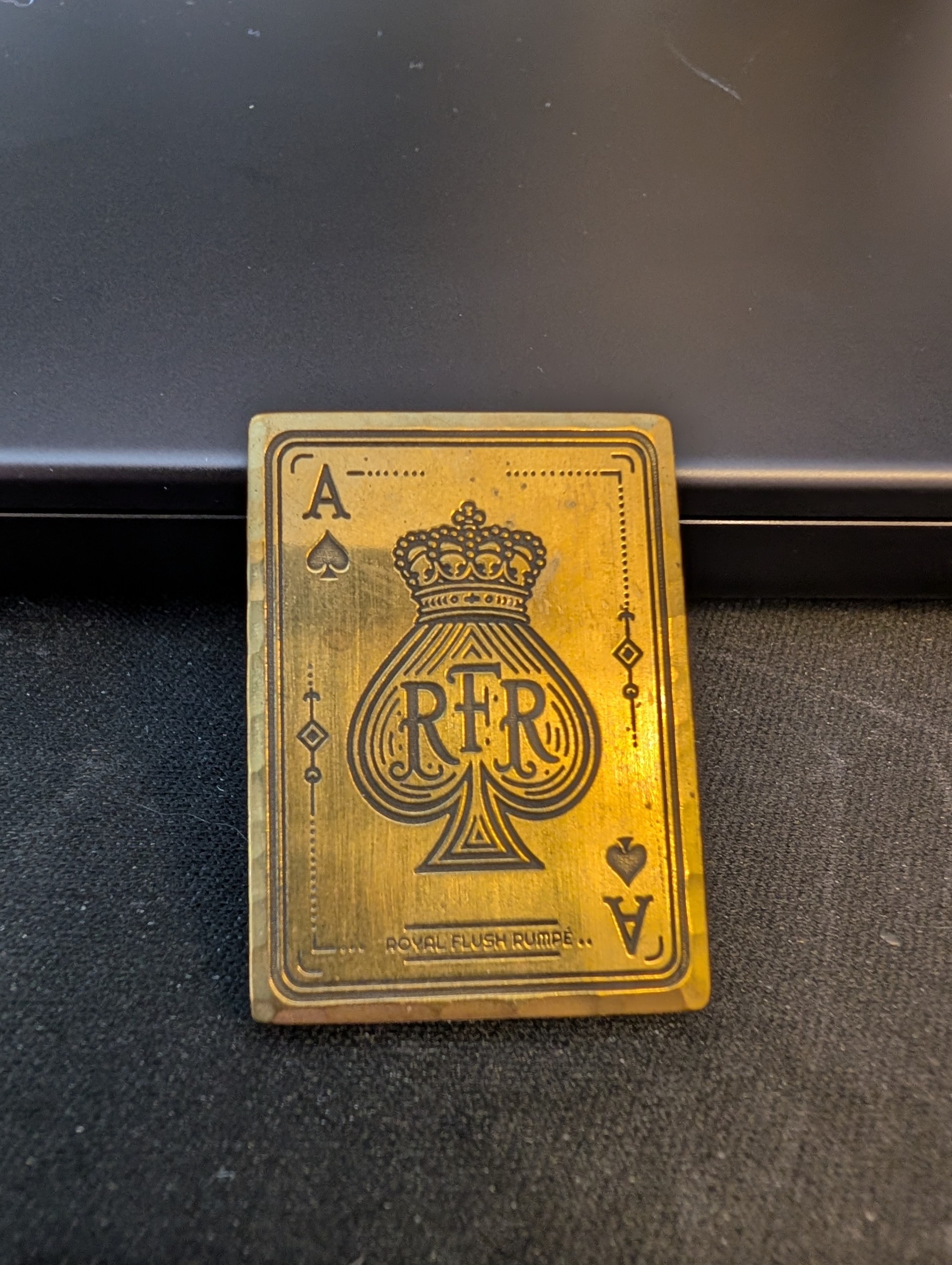 The gold-toned metal Ace of Spades plaque awarded to the winner of RFR I