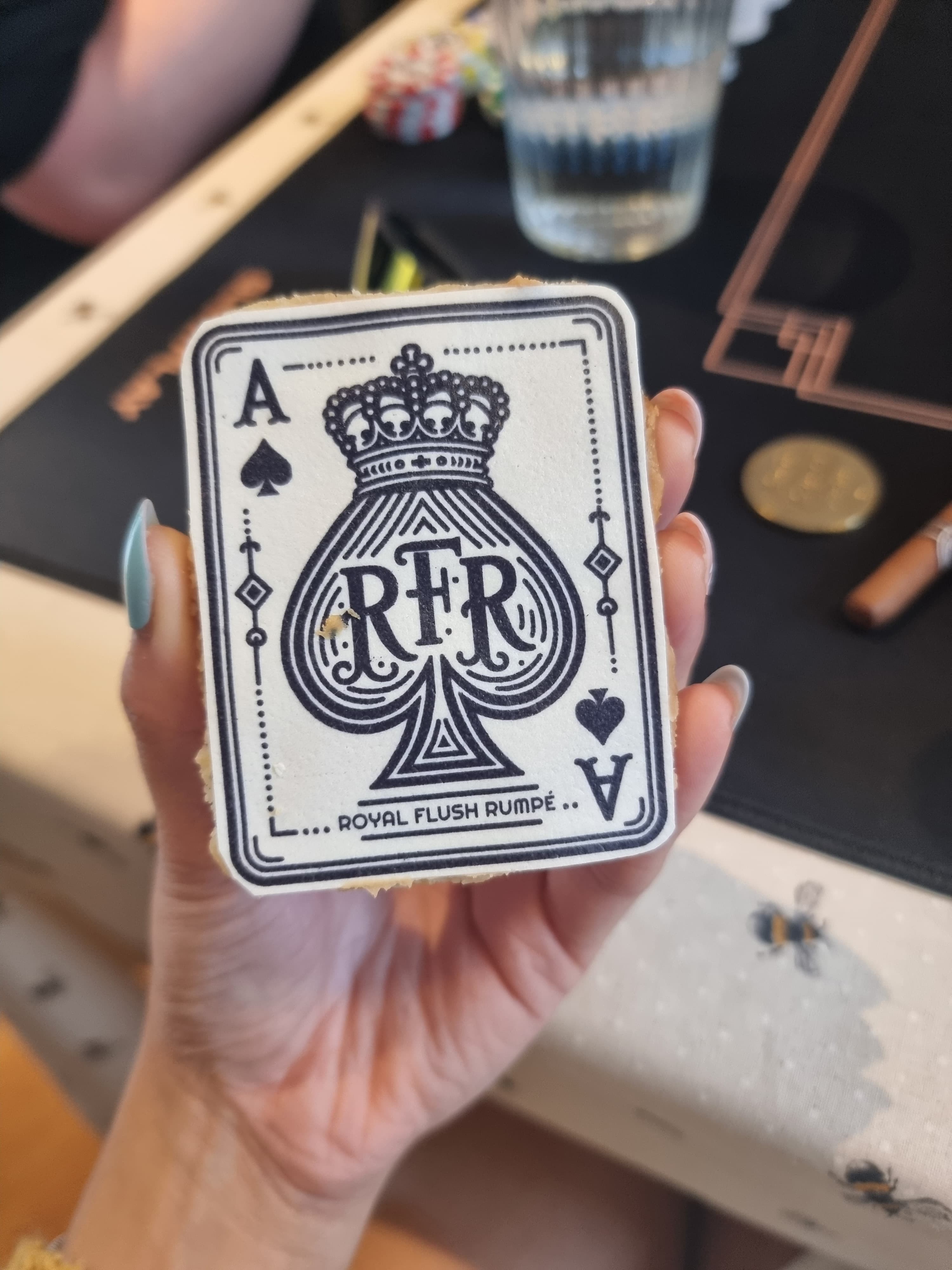 A homemade biscuit topped with icing printed with the RFR logo