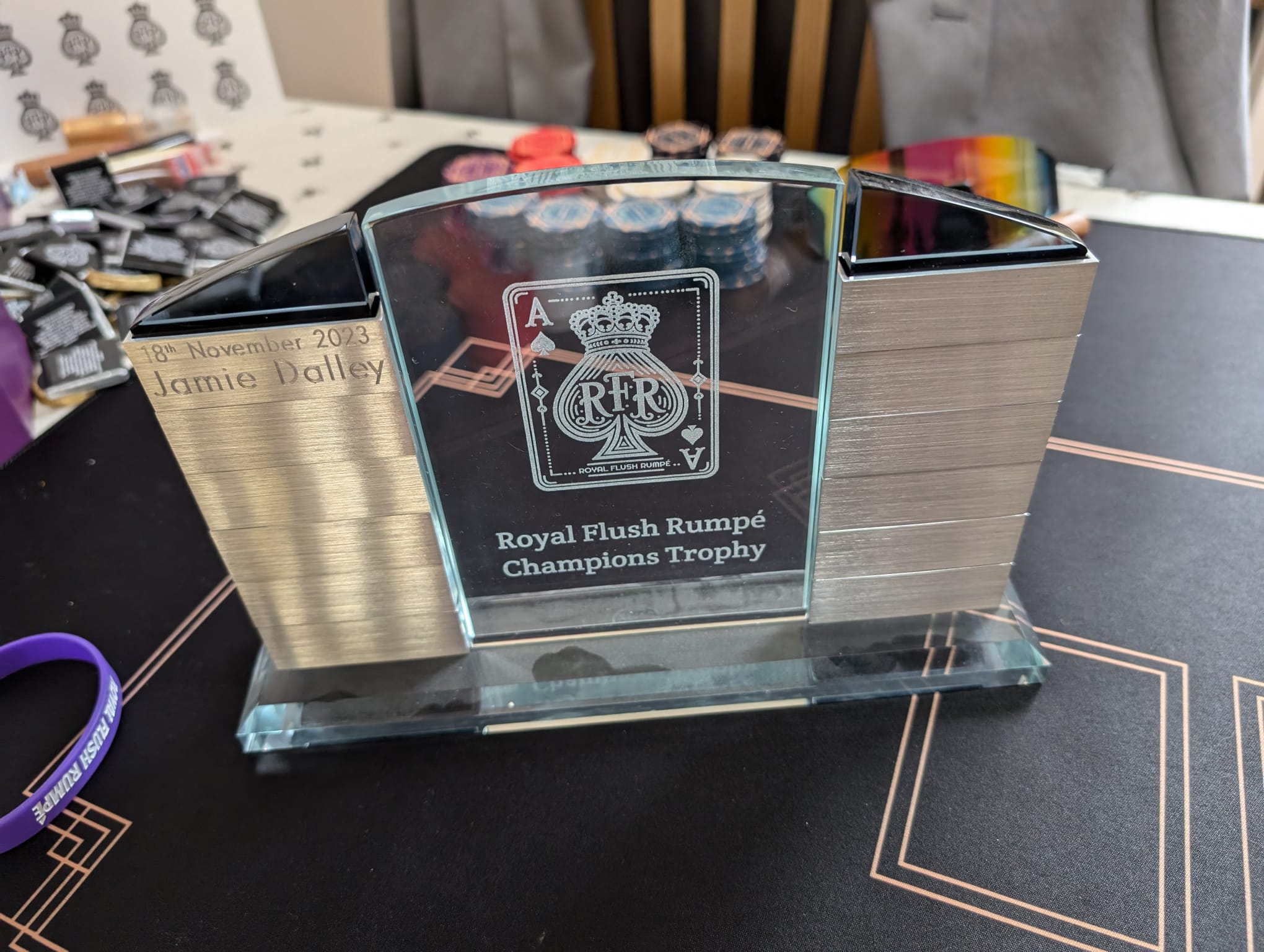 The Royal Flush Rumpé Champions Trophy displayed on the poker table