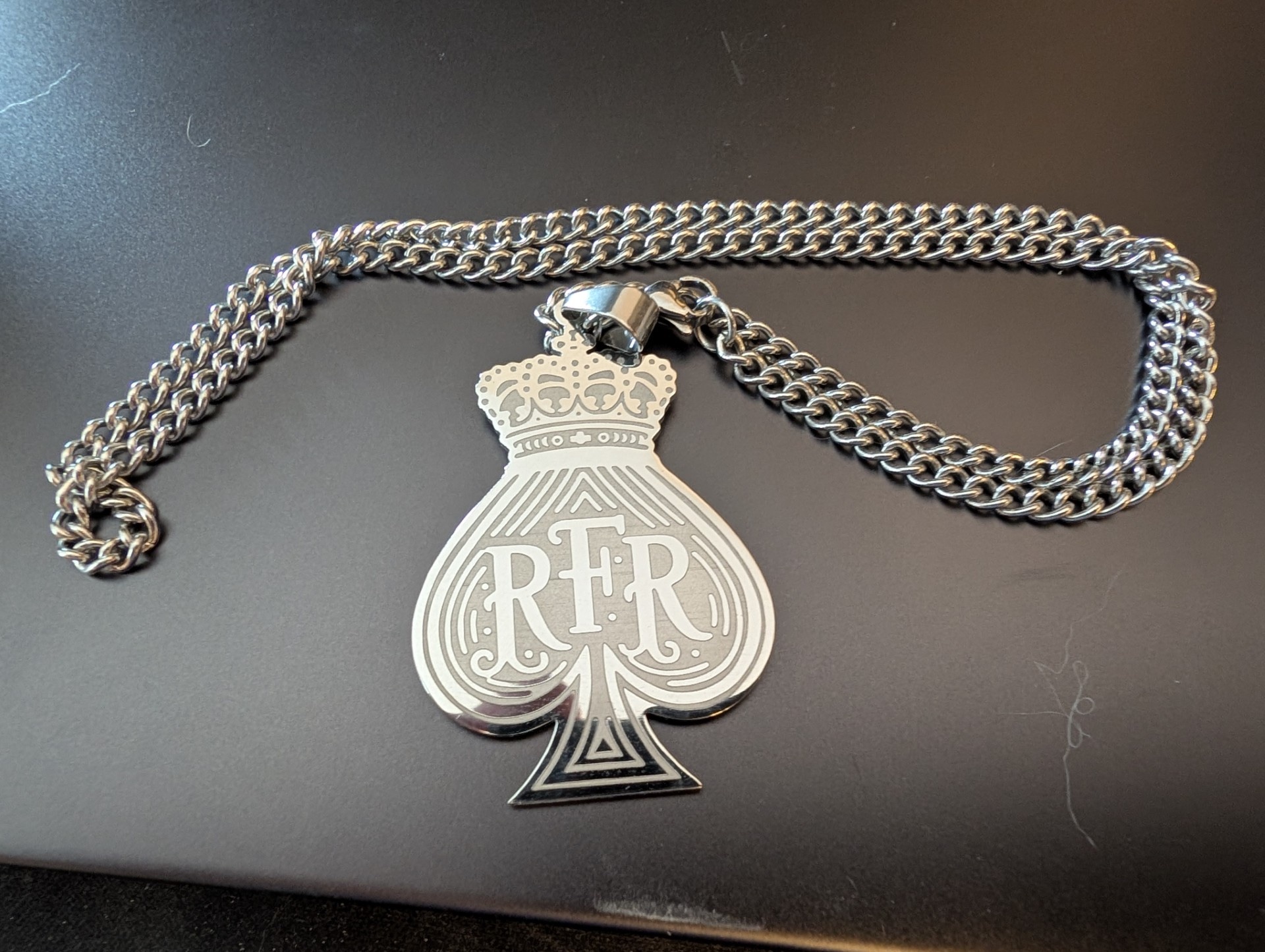 The silver crowned RFR spade necklace awarded to the RFR II runner-up