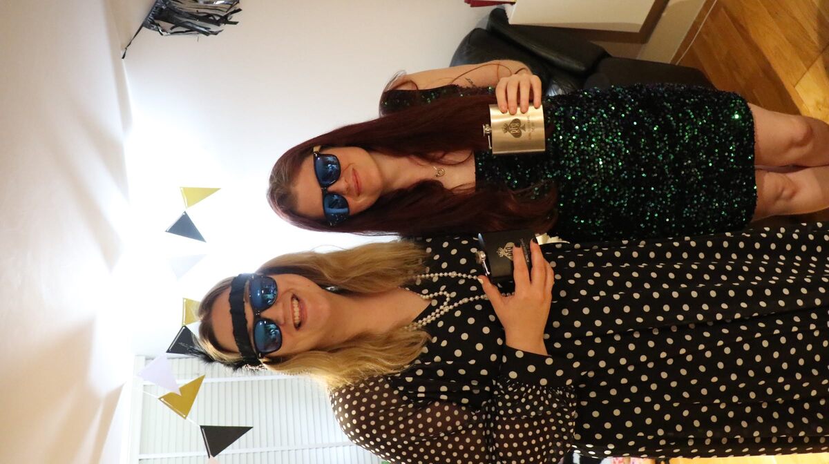 The RFR III winner and runner-up displaying their engraved metal hip flasks
